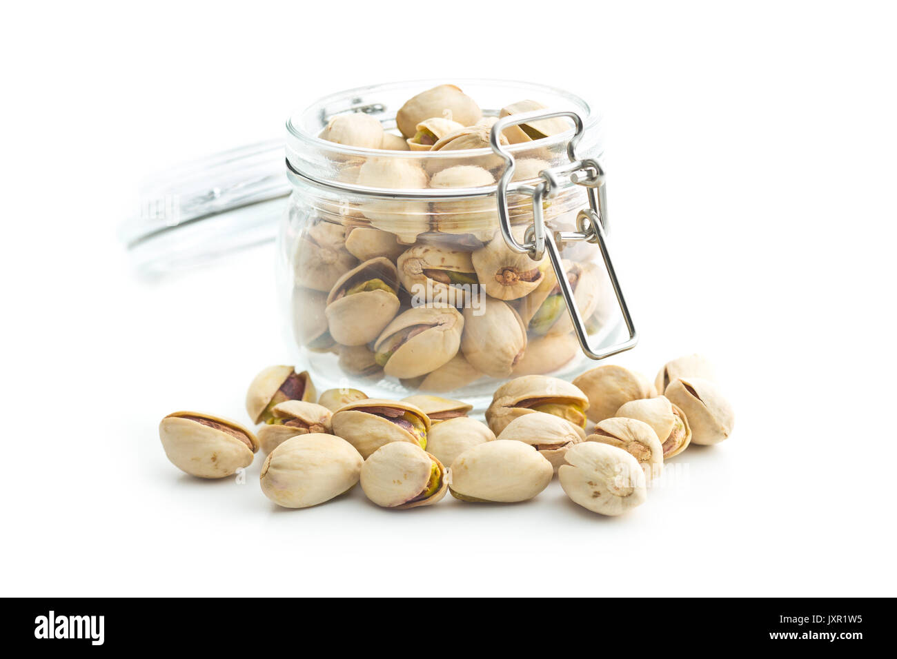 Pistachio nuts in jar isolated on white background. Glass jar with pistachio nuts Stock Photo