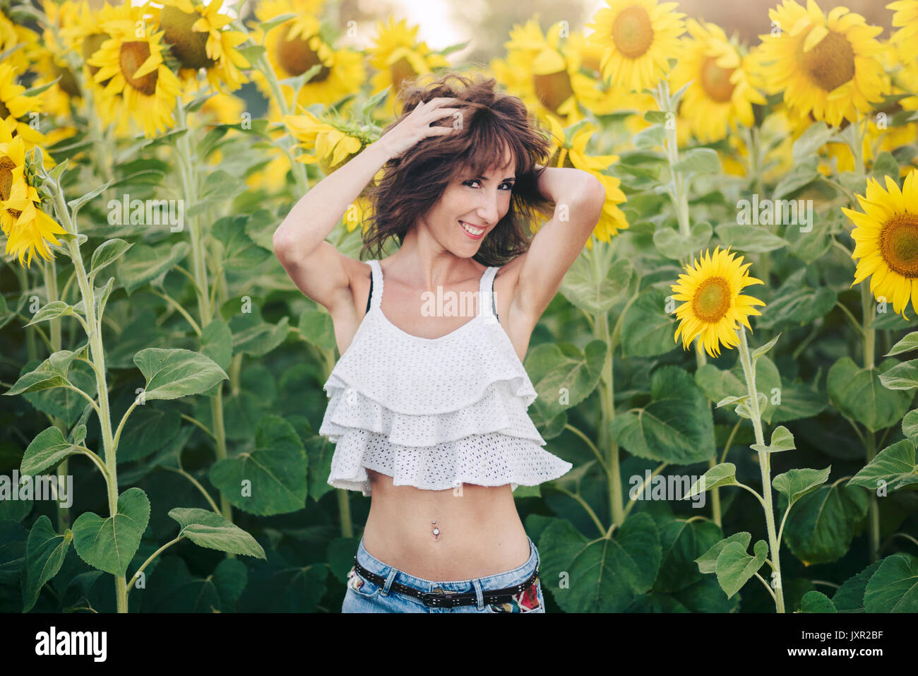 Young Woman in Sunflower Field Stock Photo - Alamy