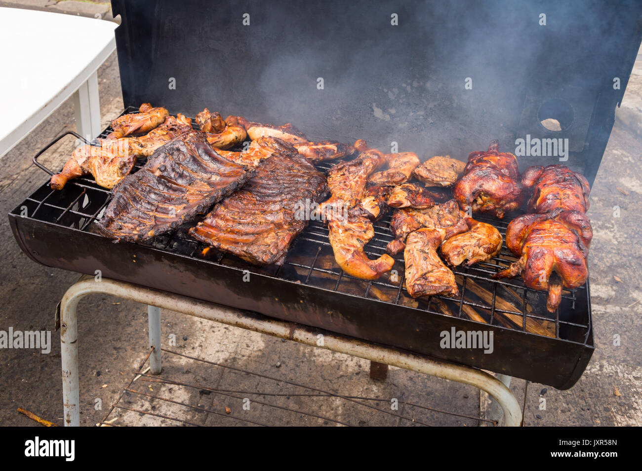 Traditional Poulet Boucane Smoked Chicken And Ribs Cooking In Bbq Barrel In Martinique Stock Photo Alamy
