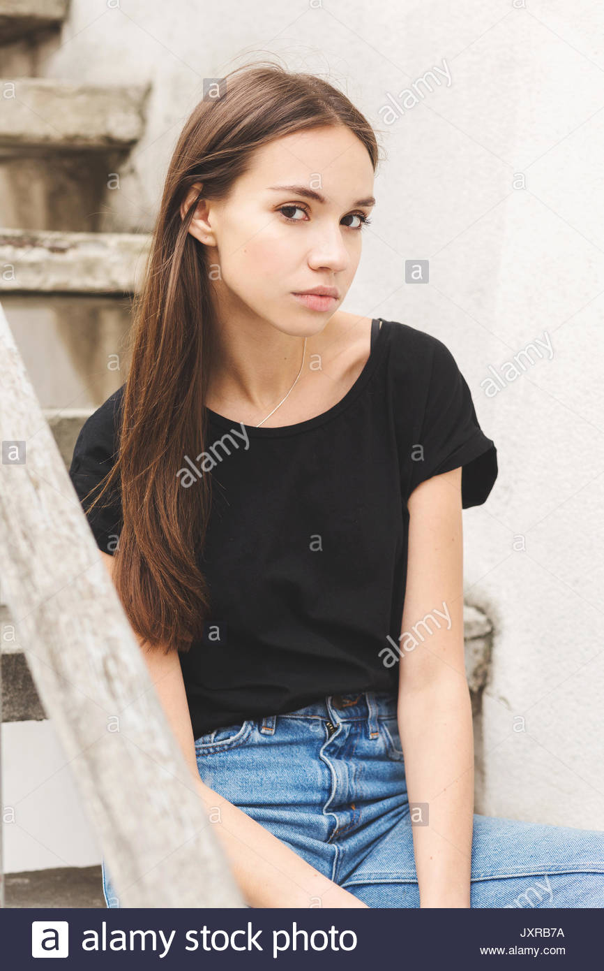 Beautiful Brunette Girl In A Black T Shirt And Mom Jeans On The Street Beautiful Brunette Girl In A Black T Shirt And Mom Jeans On The Street