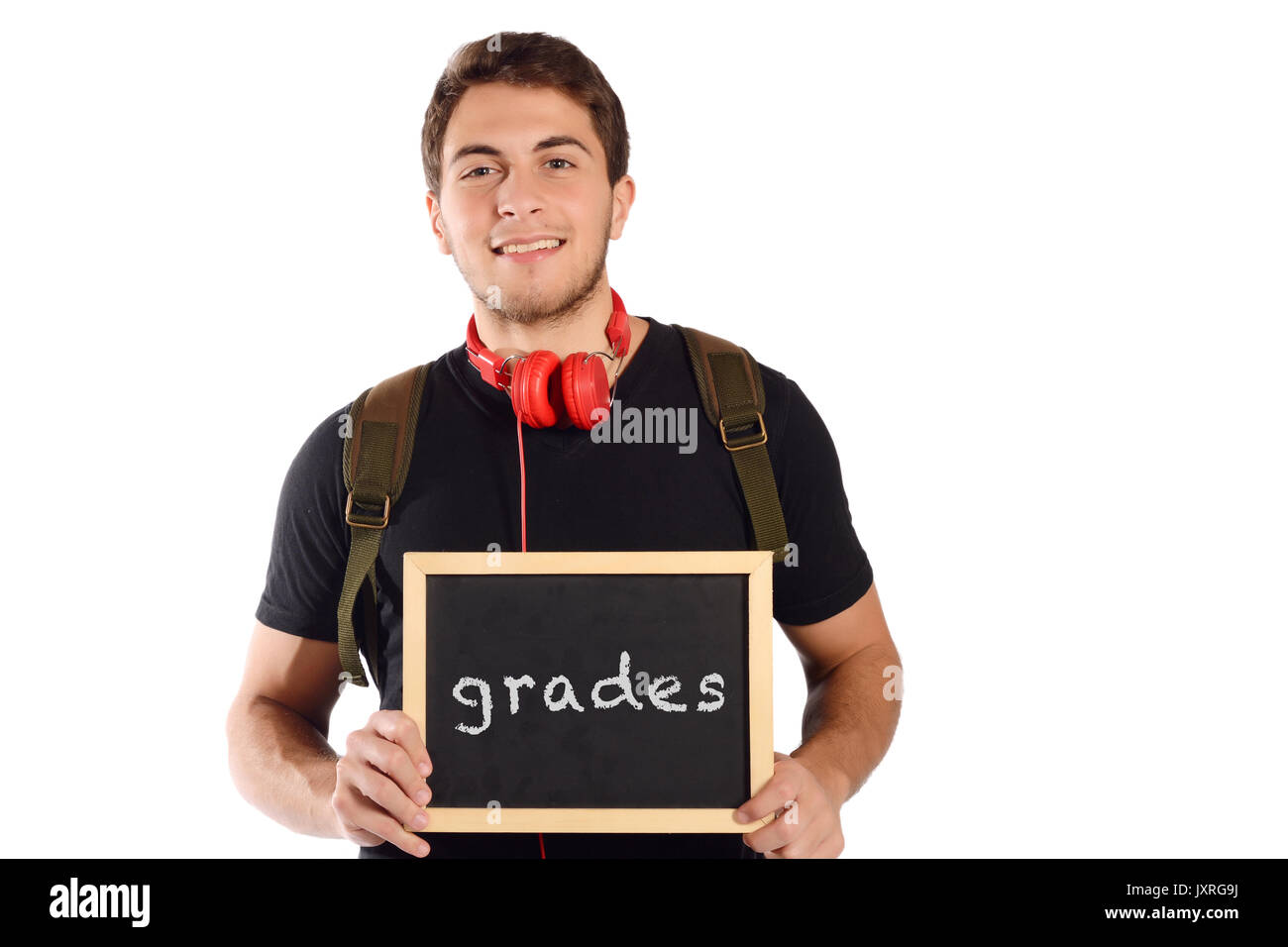 Close up of a young handsome man holding chalkboard with text 'grades'. Education concept. Isolated white background. Stock Photo