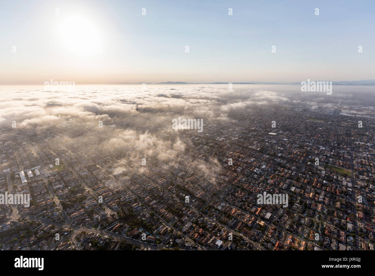 Aerial view of afternoon pacific ocean fog rolling in over the South Bay area of Los Angeles County, California. Stock Photo