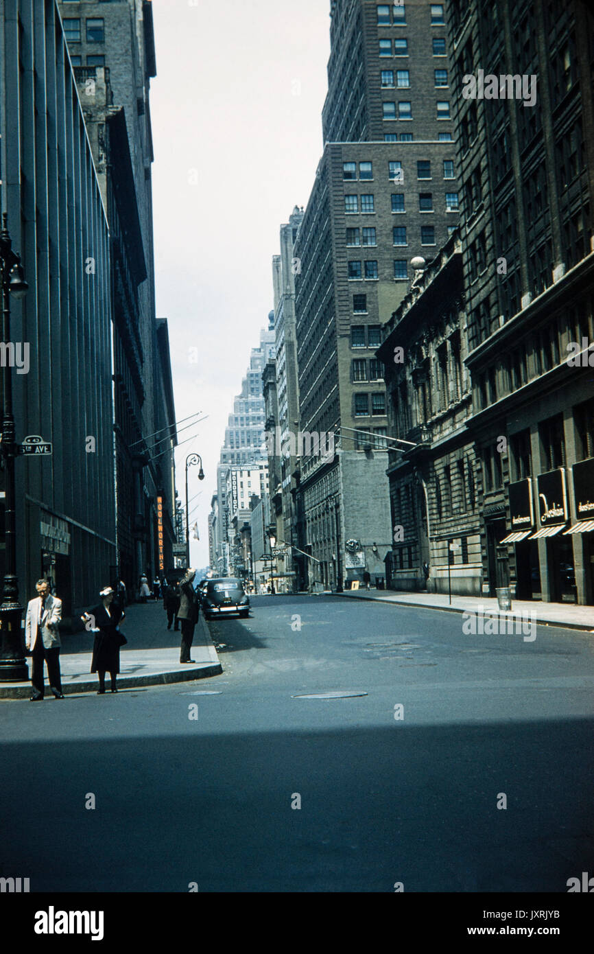 View looking up West 43rd Street from the corner of 5th Avenue in Manhattan, New York City, in 1956. Buildings that can be identified include Woolworths, Hotel Woodstock, Hotel Time Square and Hotel Diplomat. Cars and  fashion of the 1950s period are also visible. Stock Photo