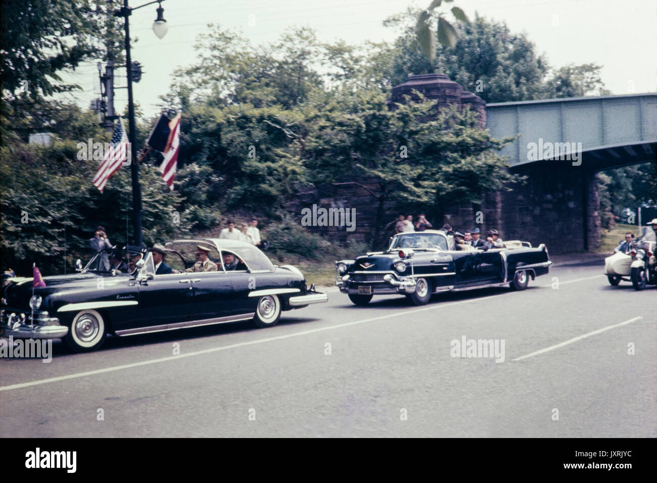 Motorcade carrying King Baudouin of Belgium through the streets of New York City in May 1959. Image shows cars and fashion of the period. Stock Photo