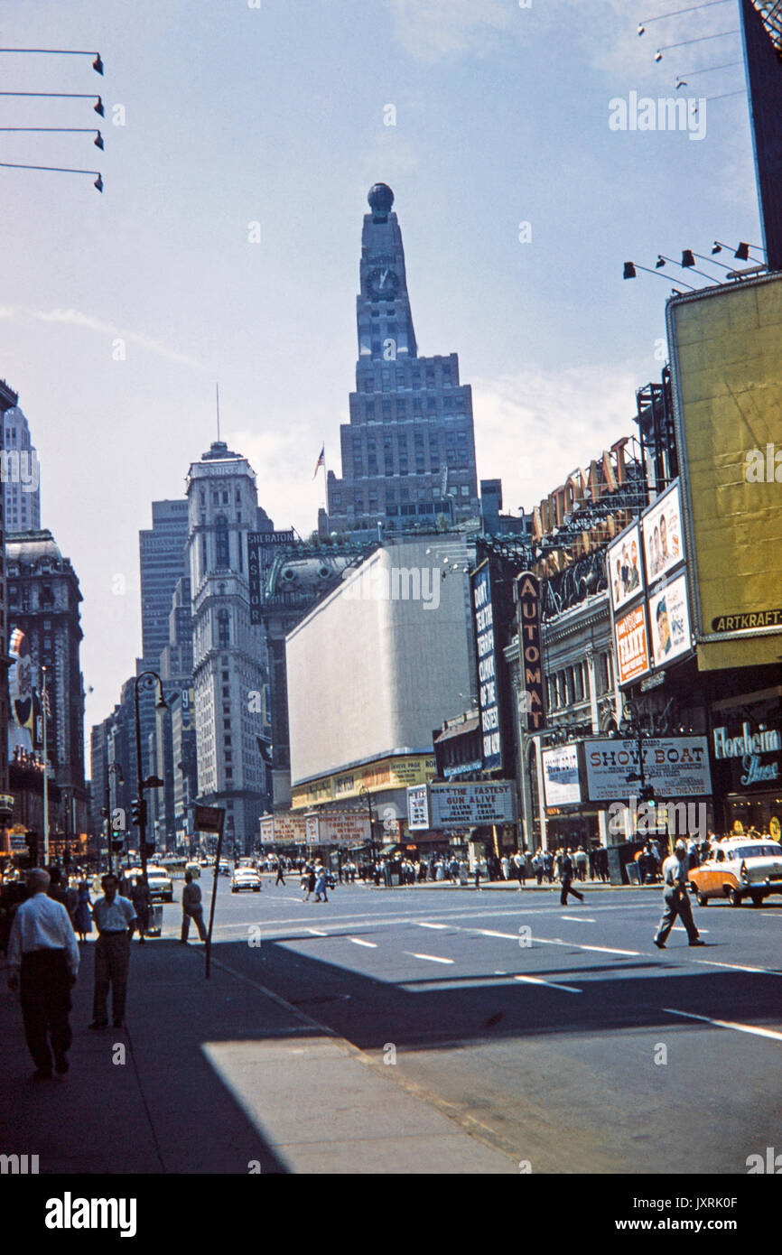 Time Square in New York City in 1956. Showing  adverts for 'Fanny', 'Fastest Gun Alive', and 'Show Boat'. Also signs for Sheraton Astor Hotel, Horn and Hardart Automat, and Pepsi Cola. Fashion and cars from the period also in the image. Stock Photo