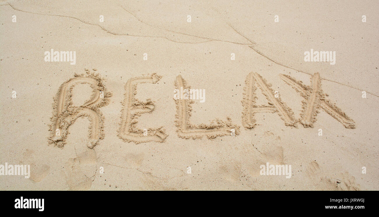 Word Relax on beach - vacation concept background. Stock Photo