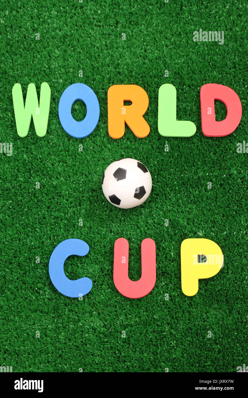 World Cup ball on atificial turf - word plastic colours Stock Photo