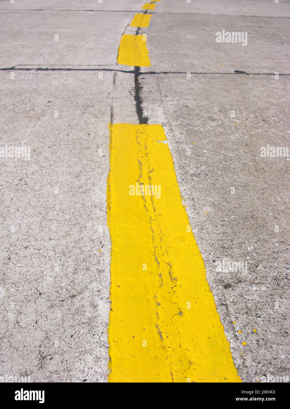 Double yellow lines on road at day Stock Photo