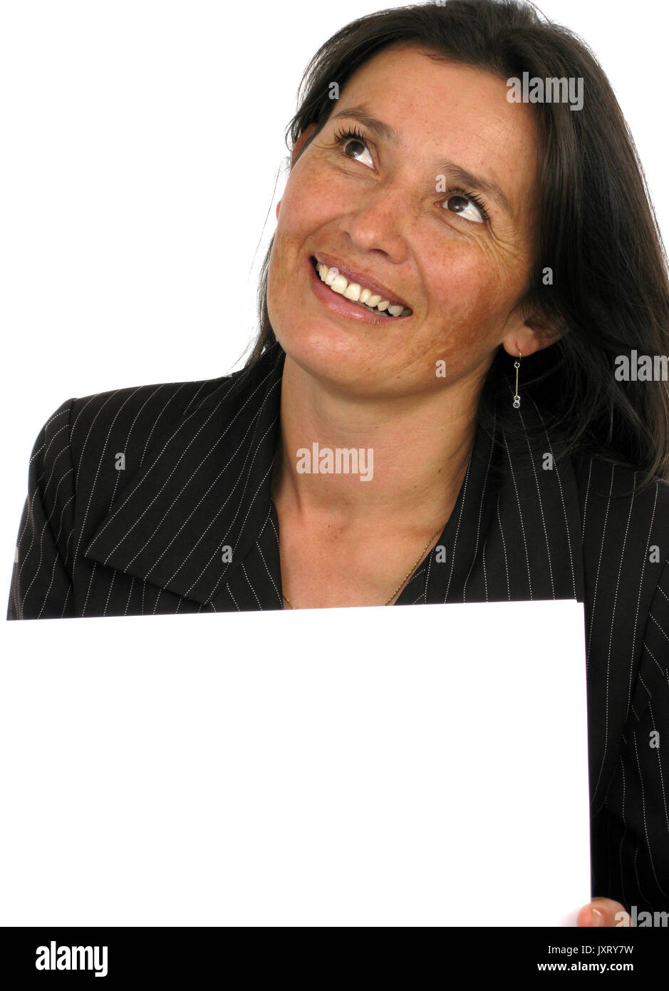 Girl smiling, thinking and holding a banner add isolated over a white background Stock Photo