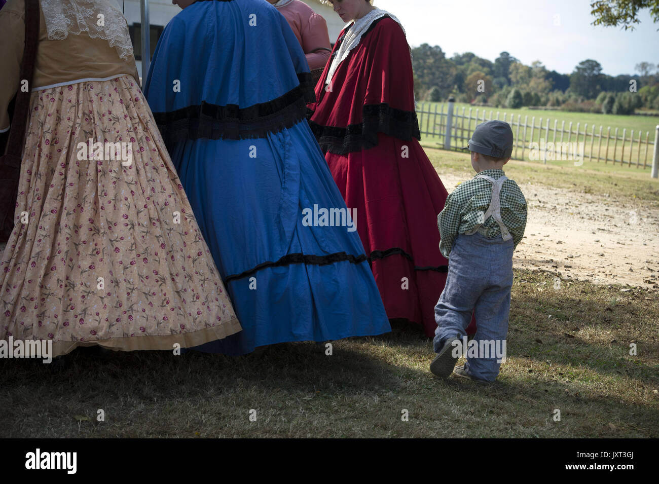 Hampton, GA, USA. 2nd Nov, 2013. Young boy in period clothing follows the hoop-skirted wives and girlfriends of the soldiers at Battle of Atlanta reenactment, Jonesboro, GA Credit: Robin Rayne Nelson/ZUMA Wire/Alamy Live News Stock Photo