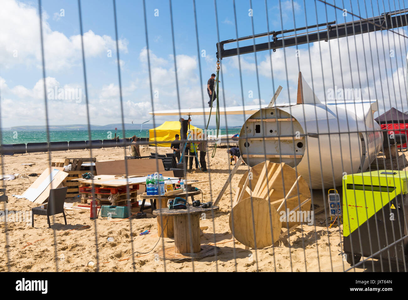 Bournemouth, Dorset, UK. 17th Aug, 2017. The UK's first aerobar is being prepared at Bournemouth beach as the 'pretend' airport takes shape. The 73ft ATR 42 aircraft is being converted into a mobile bar and the surrounding beach area transformed into airport terminal with departure lounge, duty free, club class restaurant and VIP 1st class area. 'Passengers' will be given a boarding pass on arrival. The plane will be there for 17 days and will have live entertainment. The attraction is brought to town by Poole based company Immense Events. Credit: Carolyn Jenkins/Alamy Live News Stock Photo