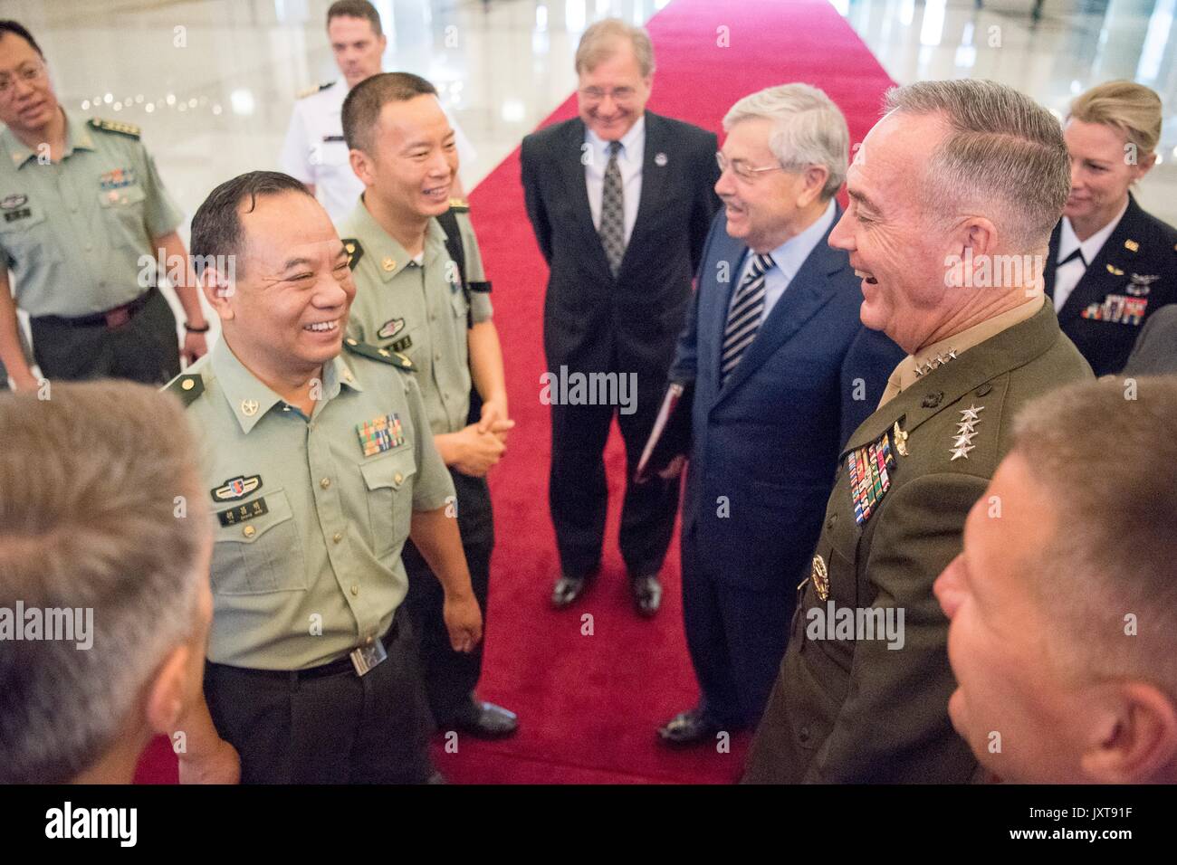 Beijing, China. 17th Aug, 2017. U.S. Chairman of the Joint Chiefs Gen. Joseph Dunford, right, chats with Chinese army officers as he arrives for his meeting with Chinese Gen. Fan Chanlong, vice chairman of the Central Military Commission, at the headquarters of the Peoples Liberation Army August 17, 2017 in Beijing, China. Dunford is in China to discuss defusing the situation in North Korea. Credit: Planetpix/Alamy Live News Stock Photo