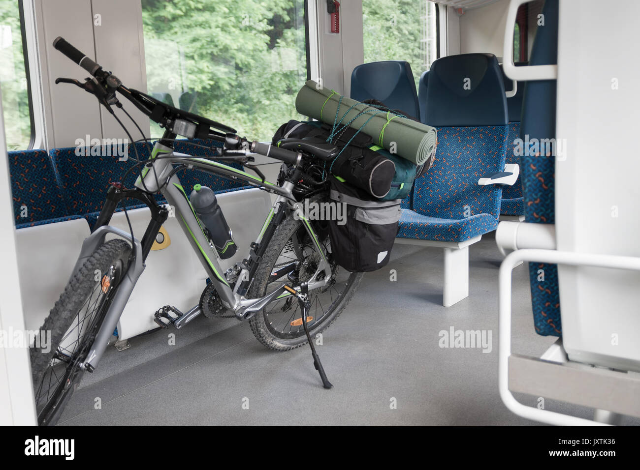 Mountain bike with saddlebags is transported in public transportation