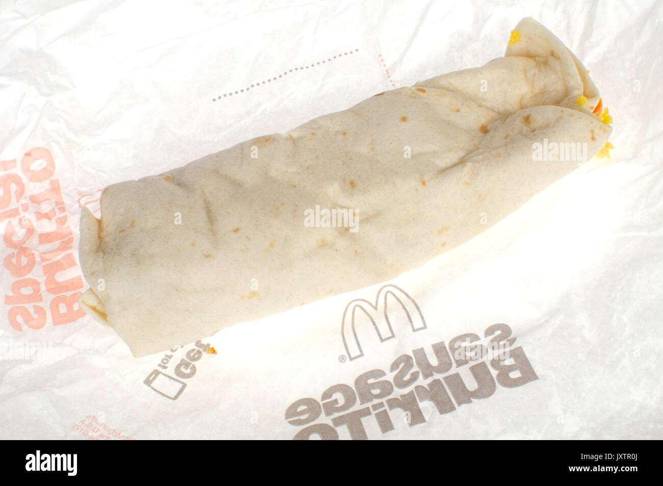 McDonald’s Breakfast Burrito sandwich on paper wrapper on white background. USA Stock Photo