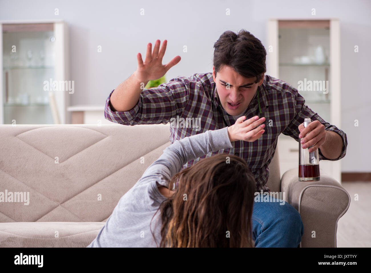 Domestic violence concept in a family argument with drunk alcoholic ...