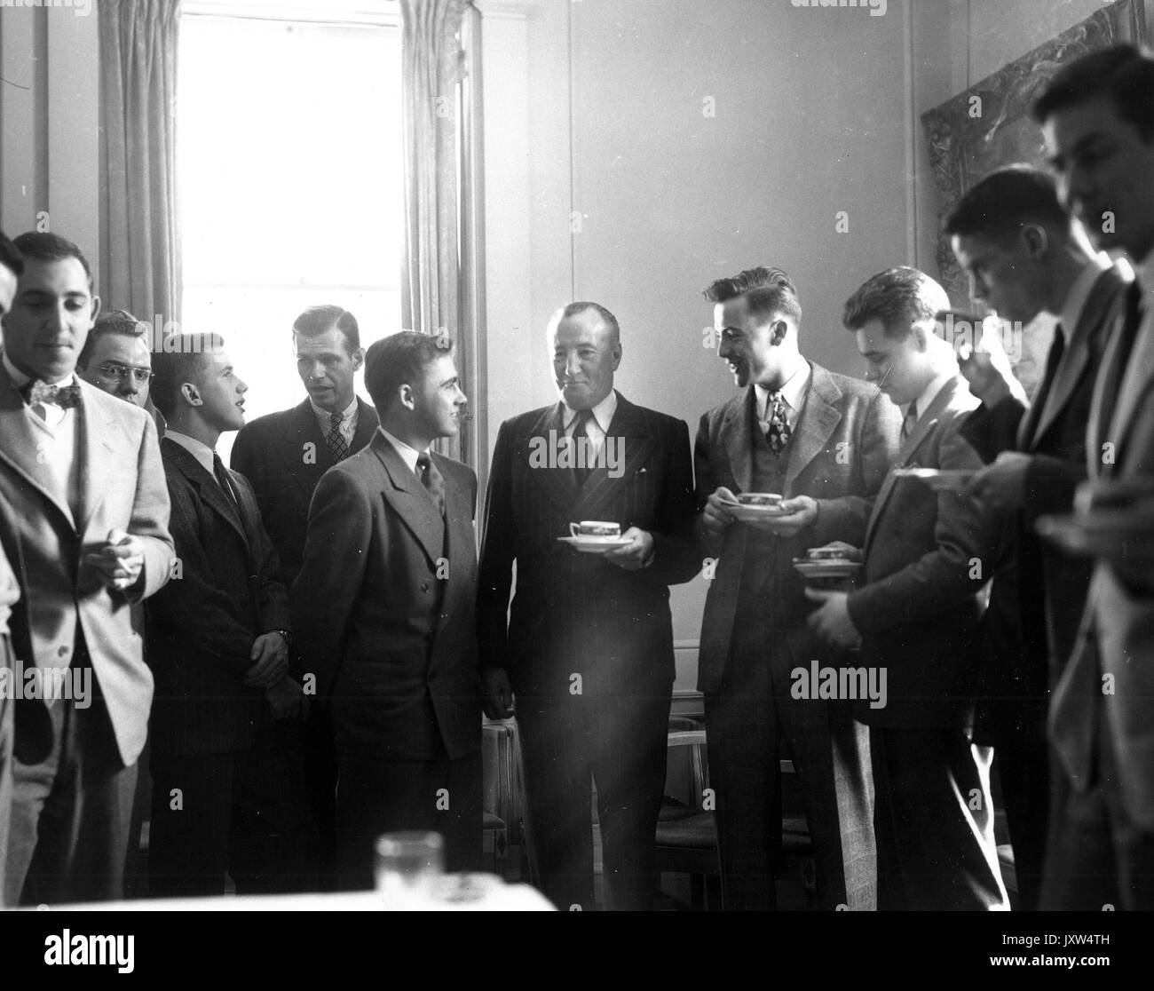 Commemoration Day, Clark Kerr, Archibald John Kerr, Inverchapel, Lord, Hiss, Alger Inverchapel [Clark Kerr], Hiss and unidentified others drinking from cups and talking, Hiss to right of Inverchapel, 1947. Stock Photo