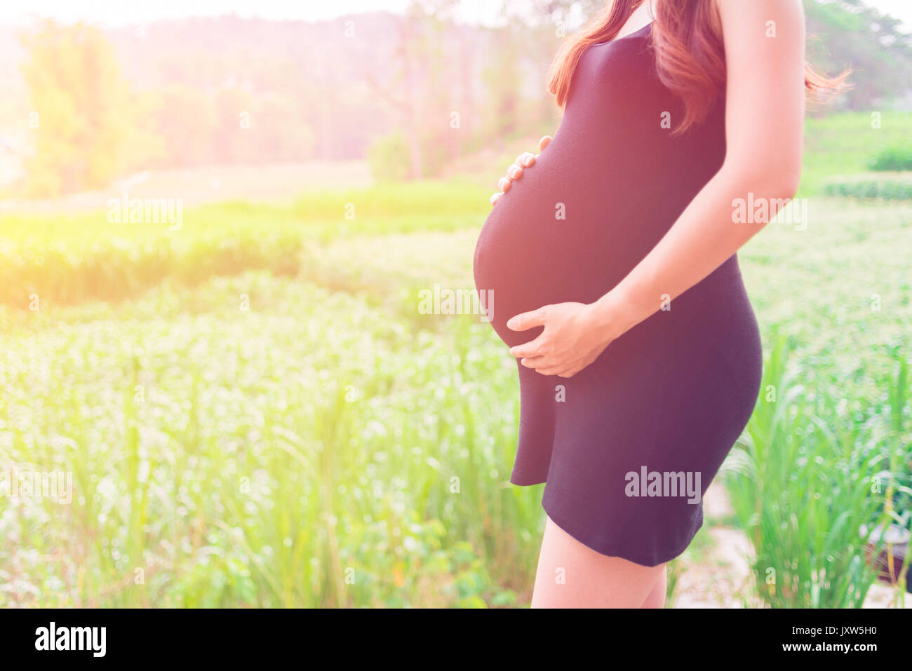a pregnant woman travel in farm, Show Belly, baby coming soon on the world Stock Photo