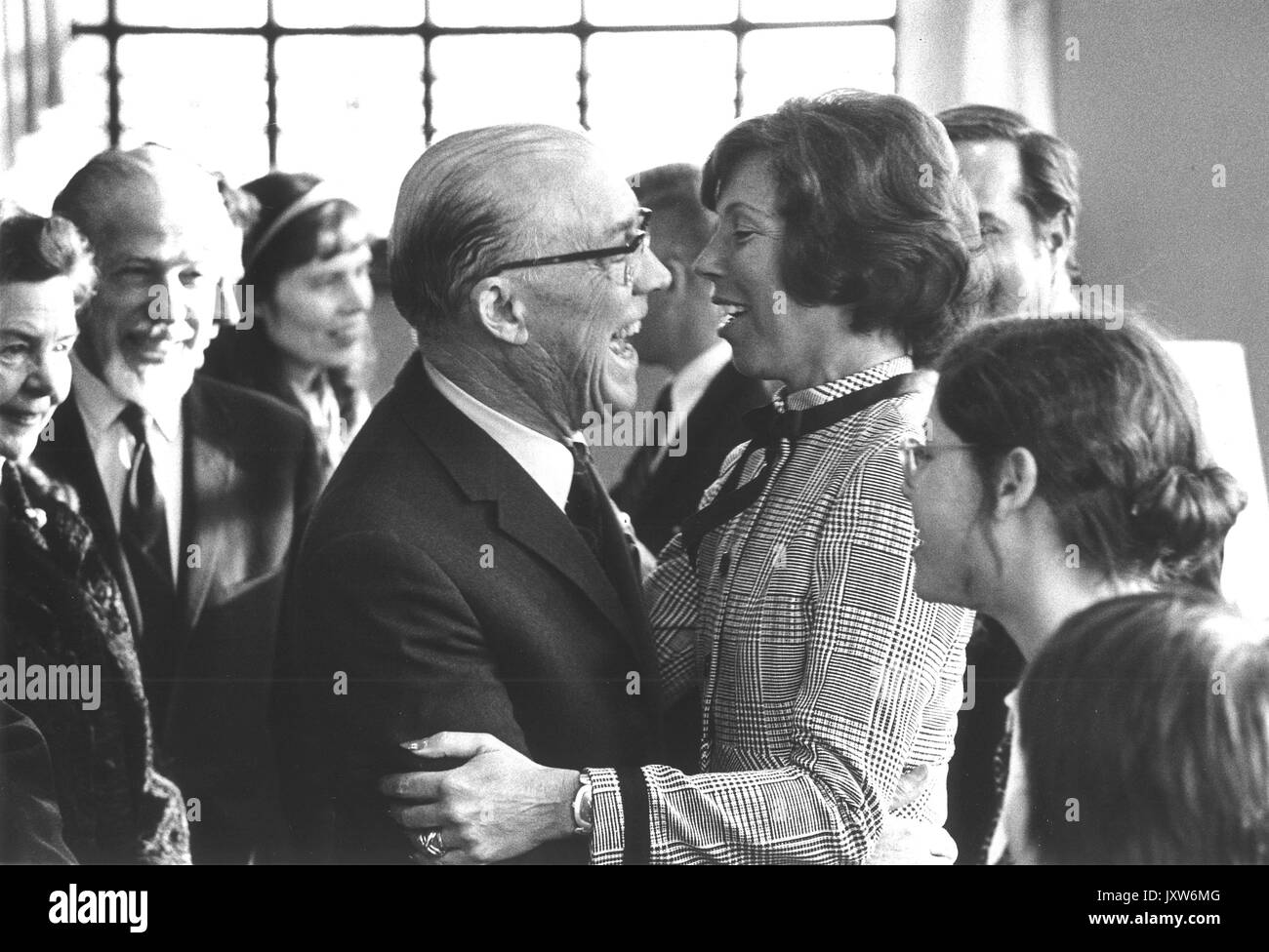 Commemoration Day, Steven Muller, Milton Stover Eisenhower, Margie Muller, Group photograph, Eisenhower embraces Mrs Muller as Muller looks on, 1972. Stock Photo
