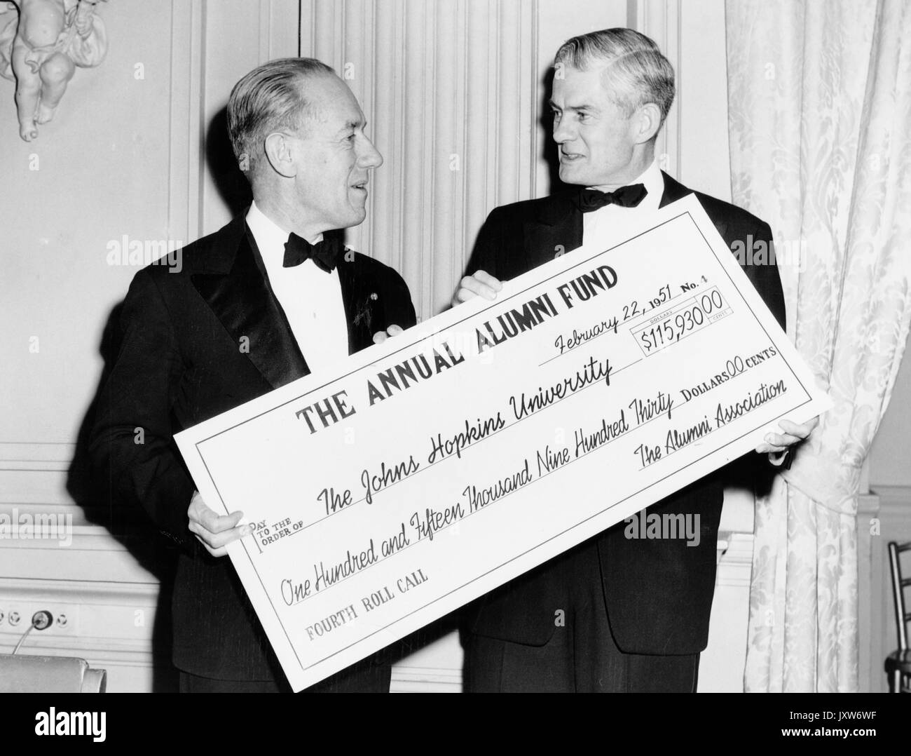 Detlev Wulf Bronk, Candid photograph, Standing, Hips up, Profile, Holding facsimile of check for Annual Alumni Fund, 1951. Stock Photo