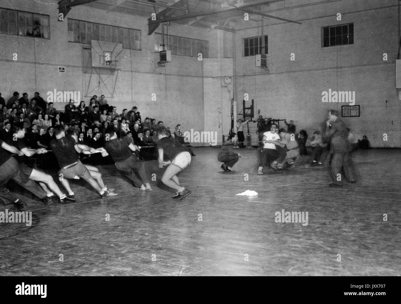 Athletics, General Candid photograph, Students engaged in tug-of-war in gym, 1945. Stock Photo