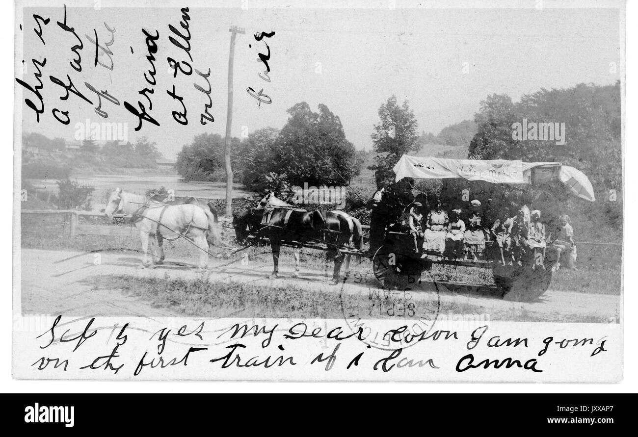 African Americans riding in wagon carried by four horses, on dirt pathway in middle of field with trees, 1915. Stock Photo
