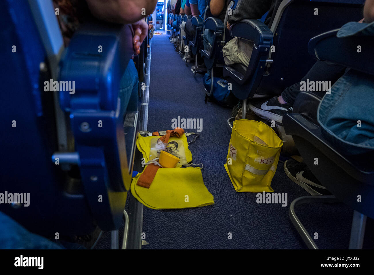 Demo kit, oxygen mask and lifevest on the floor in the aisle of a Ryanair flight before the crew do the safety demonstration, Reina Sofia airport, Ten Stock Photo