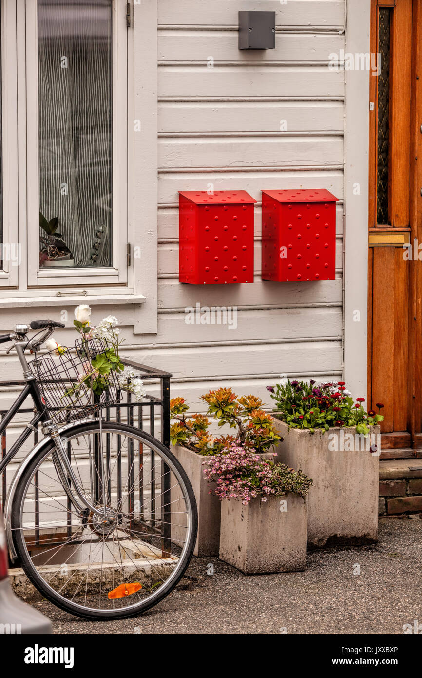 Wooden house with bike against red postboxes in Bergen. UNESCO World Heritage Site, Norway Stock Photo