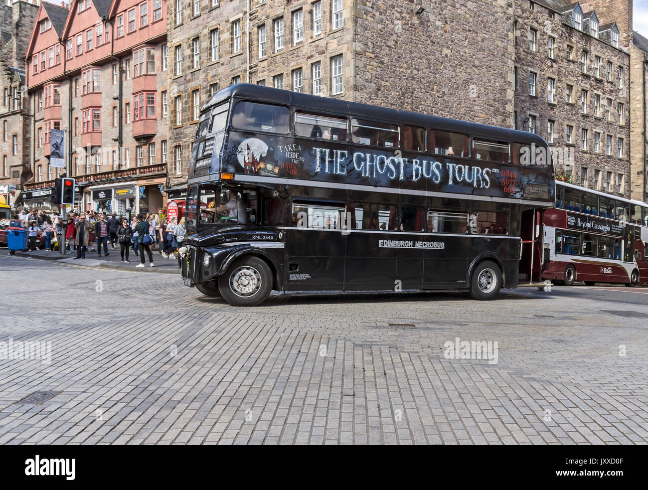 The Ghost Bus Tours bus is turning into Lawnmarket from Bank Street during Edinburgh Festival Fringe 2017 Edinburgh Scotland UK Stock Photo