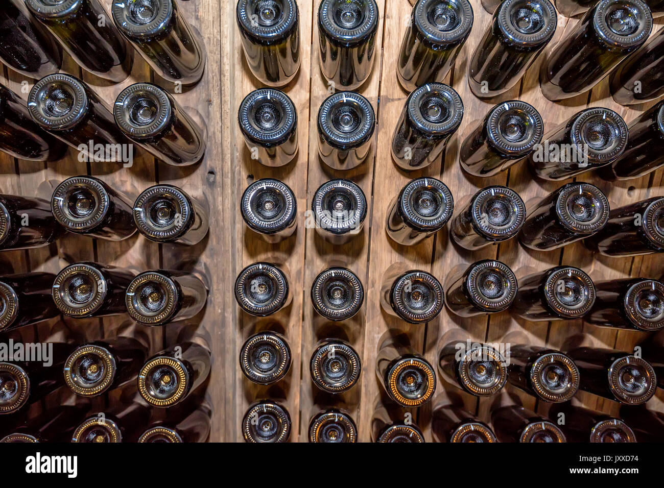Bottoms of wine bottles stacked in cellar Stock Photo Alamy