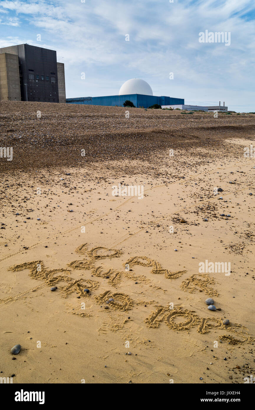Writing in the sand in front of Sizewell A and dome of Sizewell B PWR nuclear reactors, Sizewell Beach, Suffolk, England: 'I love PWR but AGR is tops' Stock Photo