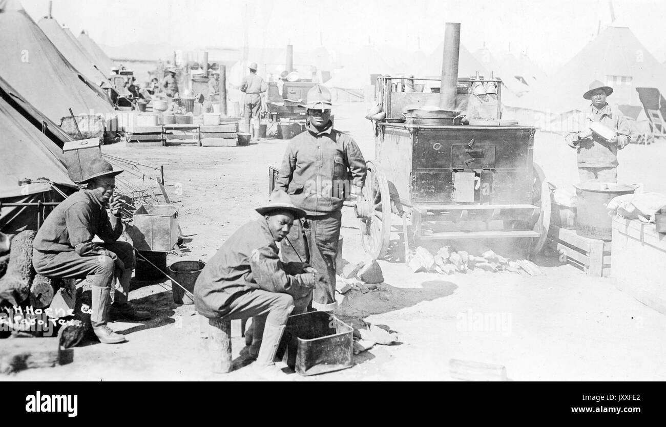Landscape portrait, African American soldiers in World War I, four men, two seated, two standing, all wearing uniforms, facing the camera, neutral facial expressions, 1917. Stock Photo