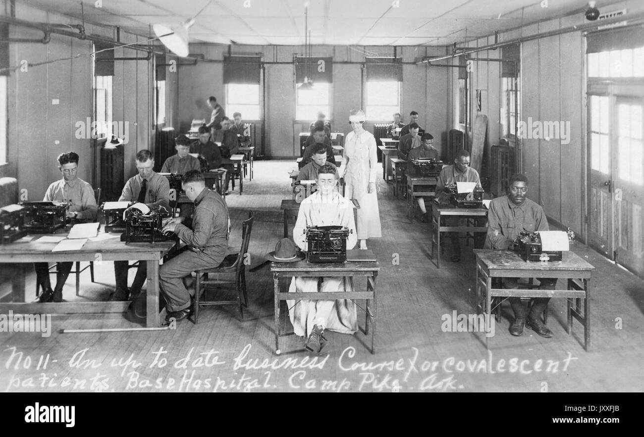 Up to date business course for covalescent patients at Base Hospital in Camp Pike, Arkansas; classroom depicted with students, both male and female, typing on typewriters, with a teacher walking through the aisle, Arkansas, 1917. Stock Photo
