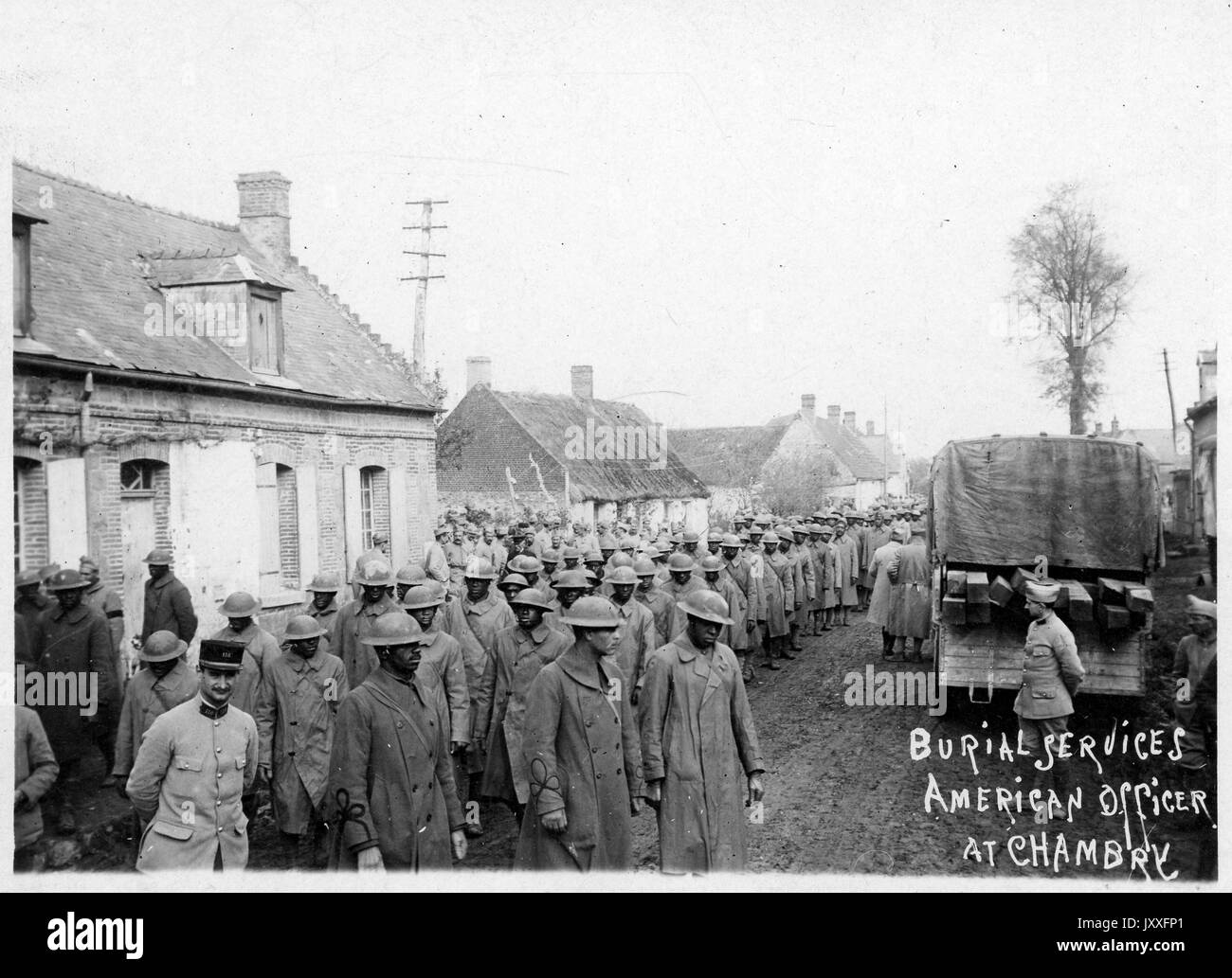 WWI Burial services of American officer at Chambry, large group of African American soldiers in uniforms and hats organized outside for burial service, full portrait, landscape shot, 1917. Stock Photo