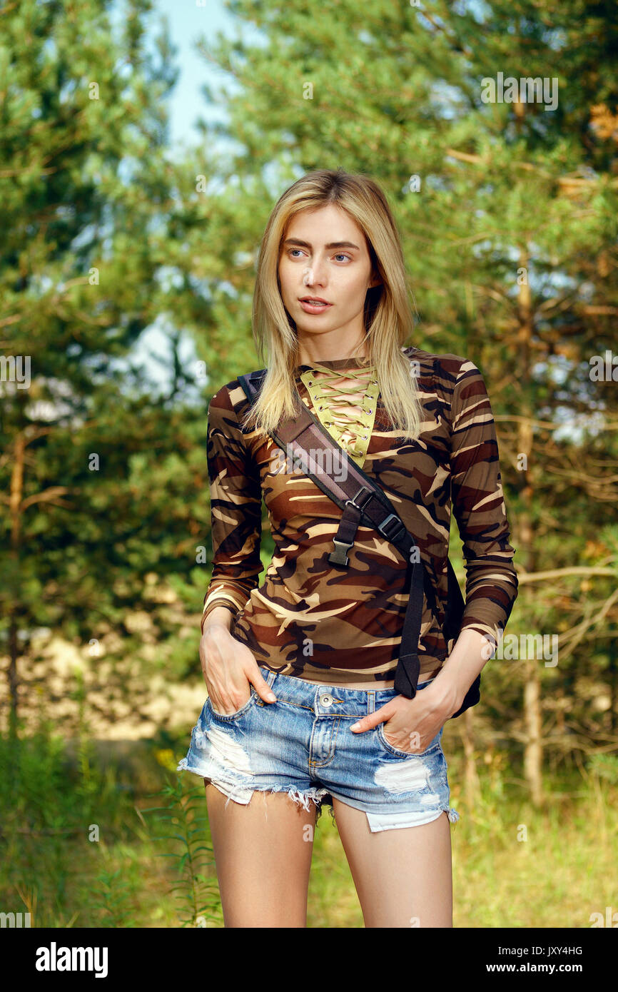 camo shirt, jeans shorts with backpack 