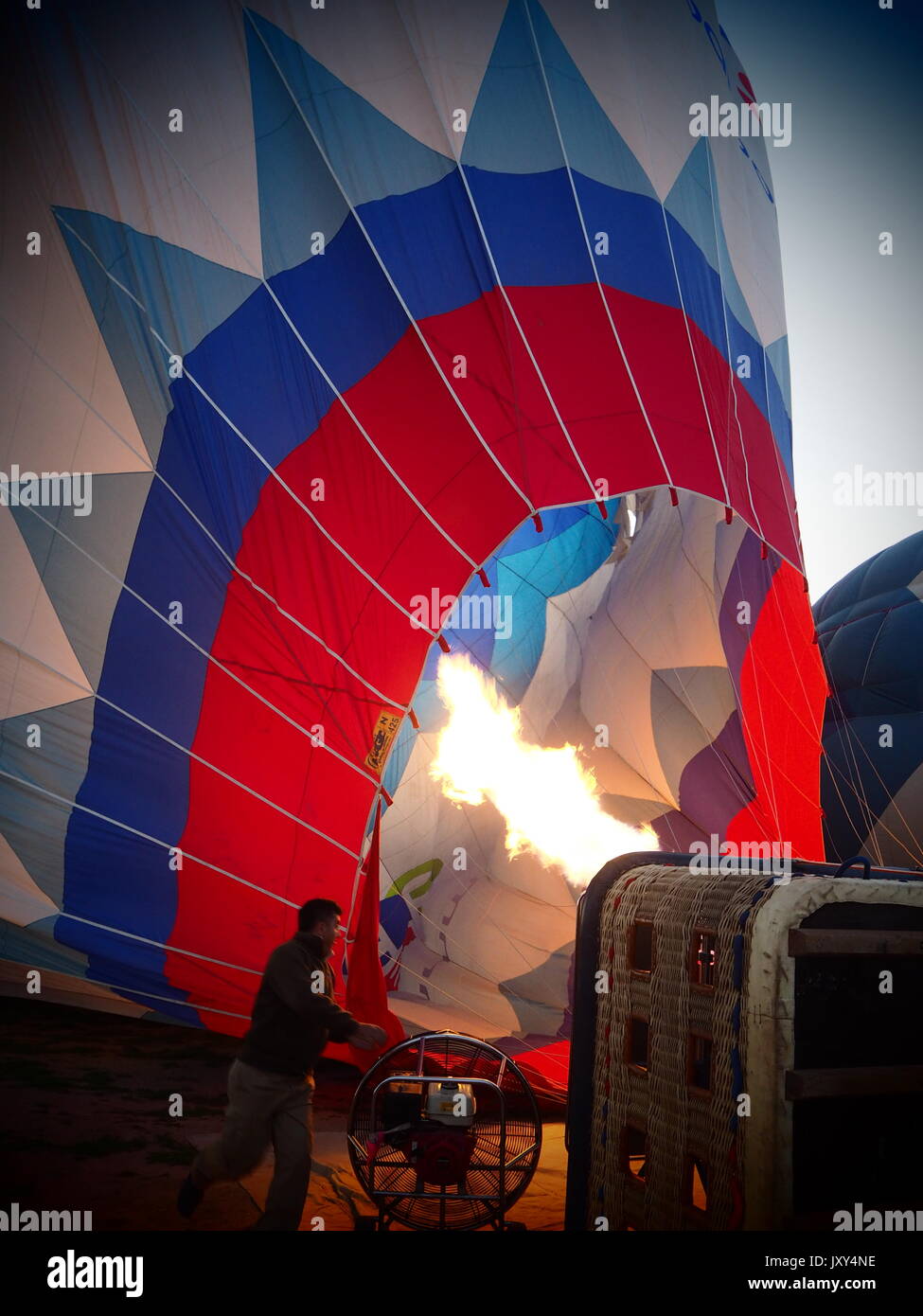 The pilot is working on making the hot air balloon fly Stock Photo