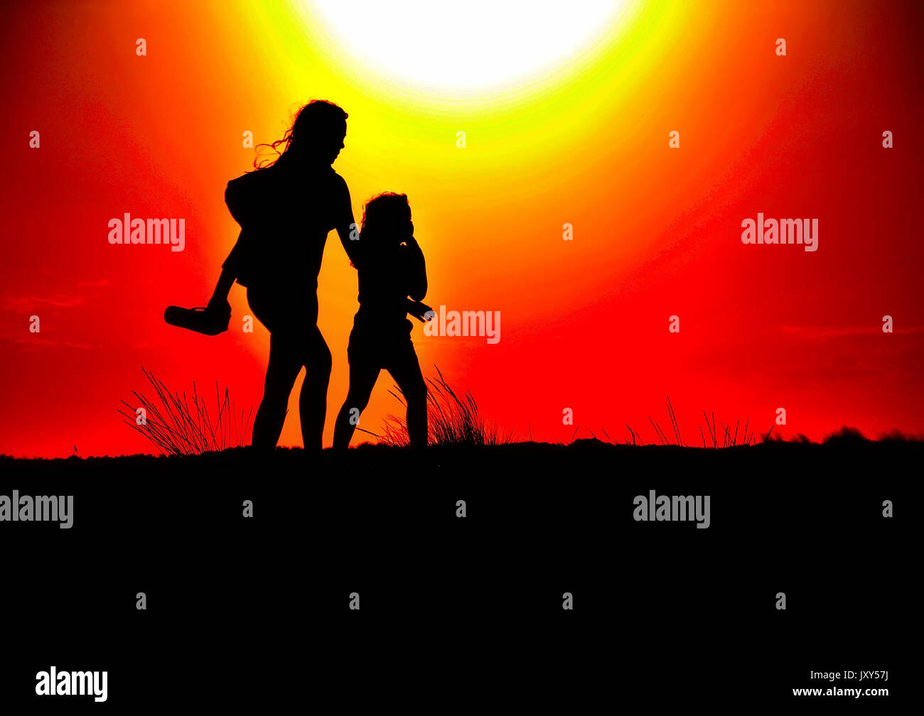 Silhouettes of people who are walking at sunset Stock Photo - Alamy