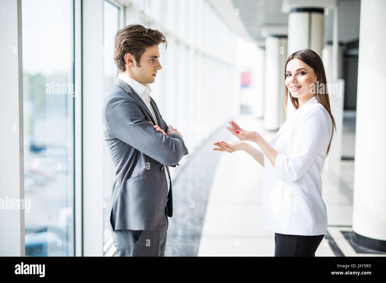 Business men and women talking with a smile on the background of the ...