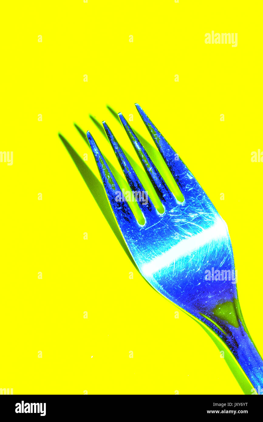 Blue Fork on Yellow Background Stock Photo