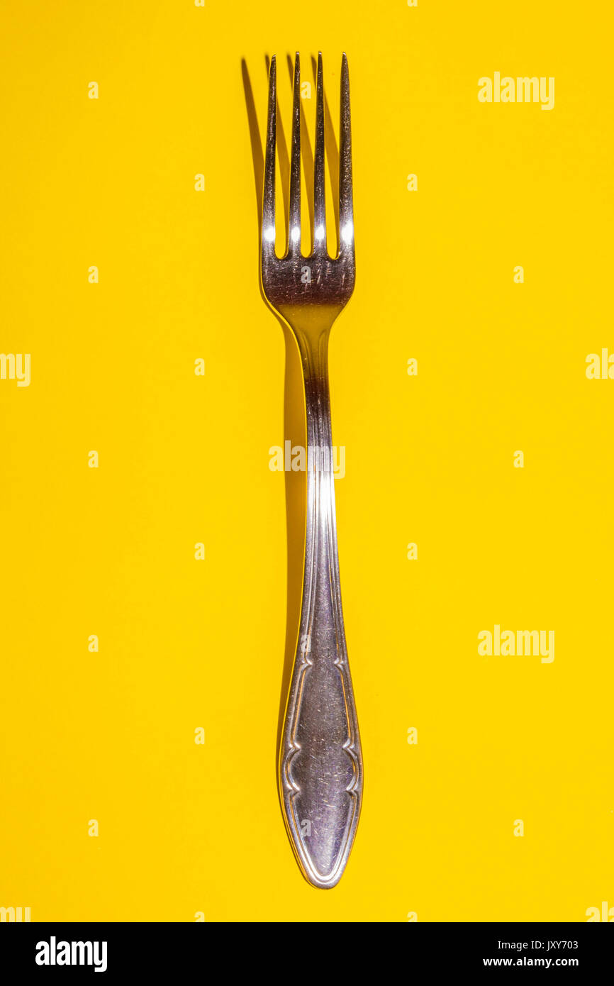 Fork on Yellow Background Stock Photo