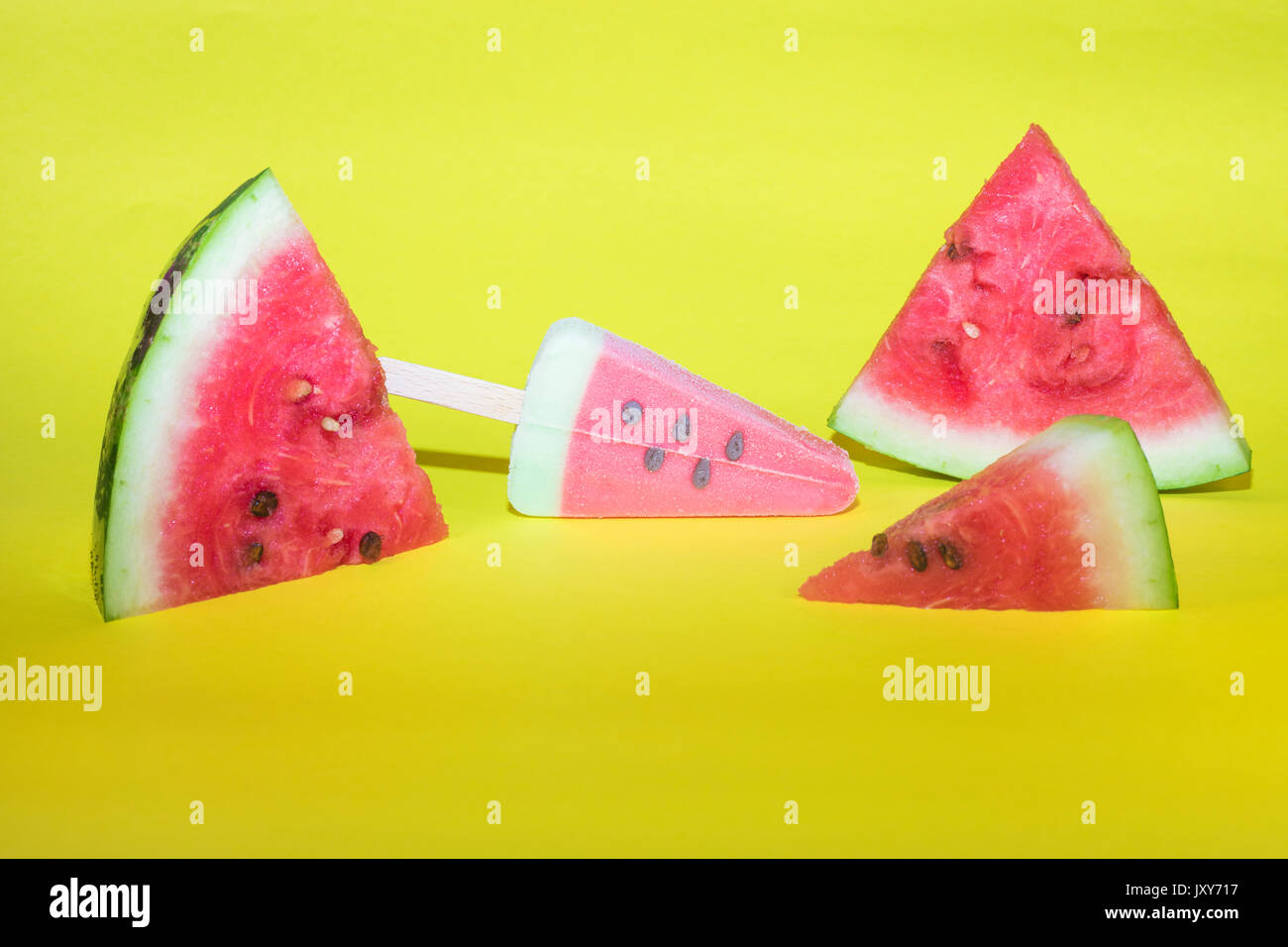 Watermelon slices and ice cream on yellow background Stock Photo