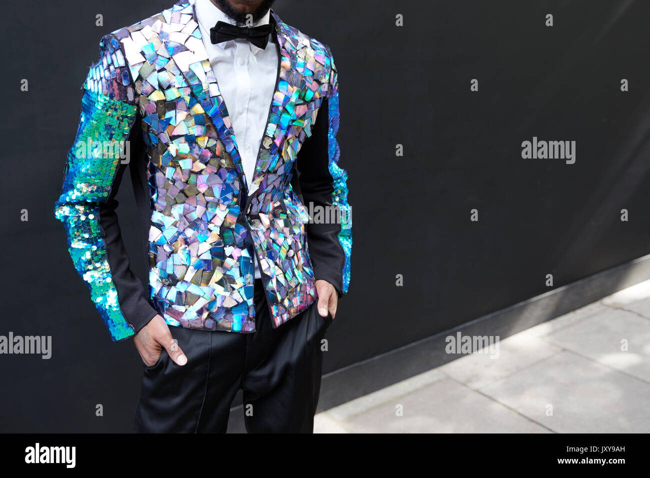 Mid section of man in sequinned prismatic jacket and bow tie Stock Photo