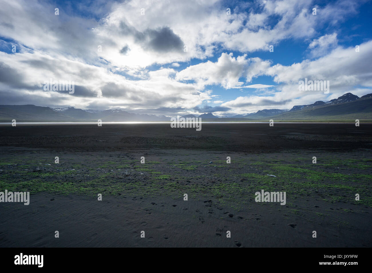 Iceland - Endless flat black sand landscape between snowy mountains Stock Photo