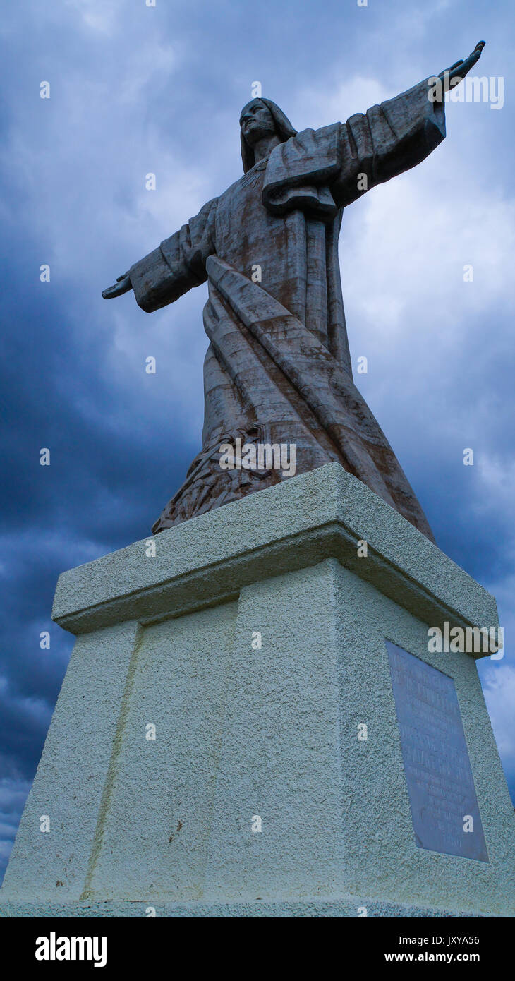Madeira - Garajau - Christo Rei statue of jesus christ with dark clouds in background Stock Photo
