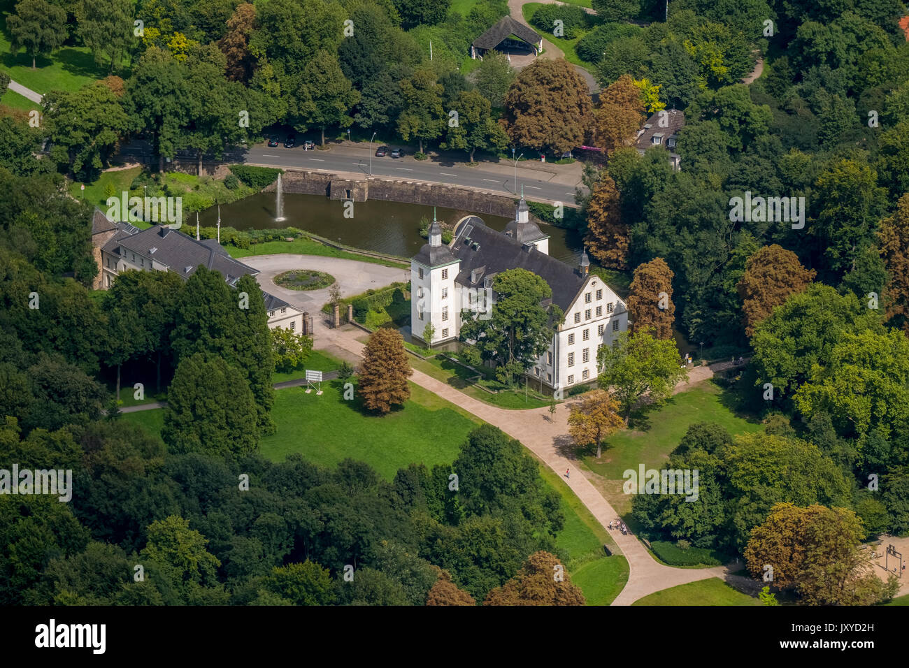 Schloss Borbeck, baroque moated castle, main house and an elongated farm buildings, curly gable, castle park is designed as an English landscape garde Stock Photo