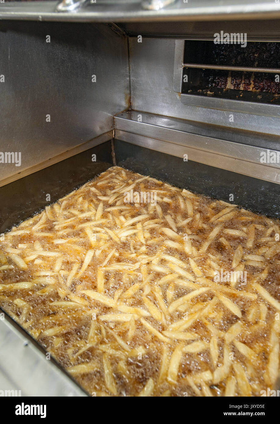 Frying chips in Lusitania Fisheries, Cape Town. Stock Photo