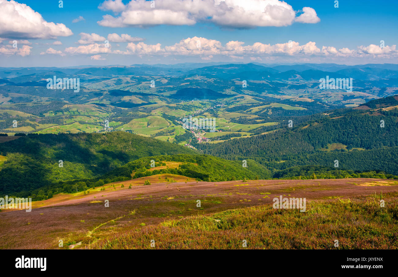 village in valley viewed from a hill. lovely landscape in late summer evening Stock Photo