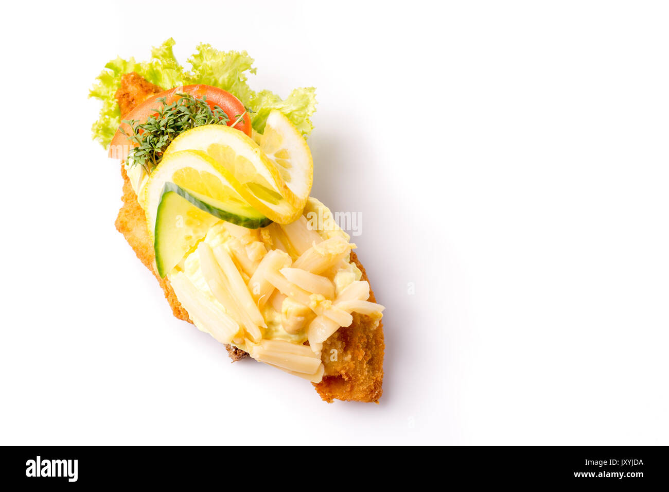 Danish specialties and national dishes, high-quality open sandwich, isolated on white background. fish fillet and garnished with remoulade and lemon Stock Photo