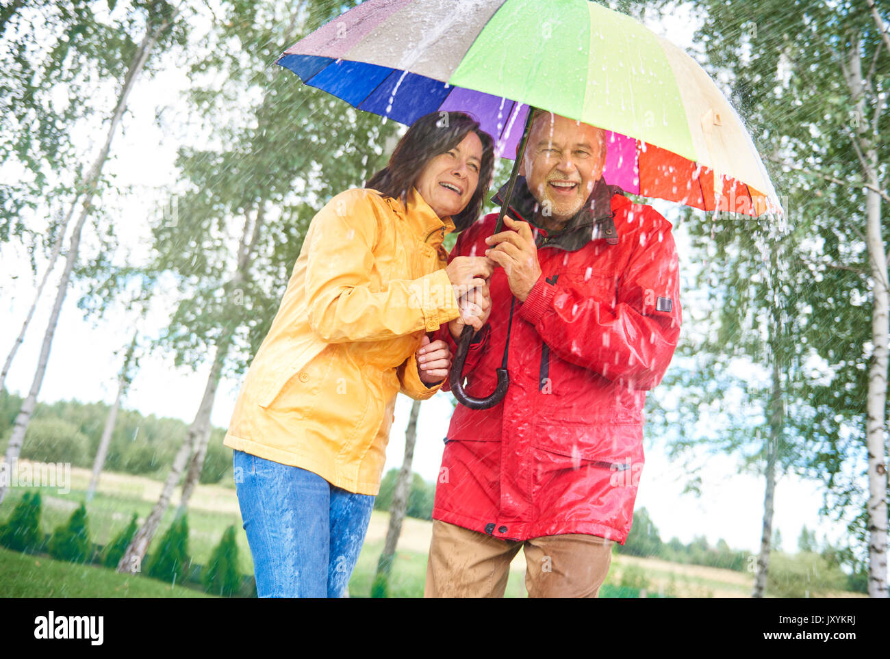 Couple with a rainbow umbrella Stock Photo