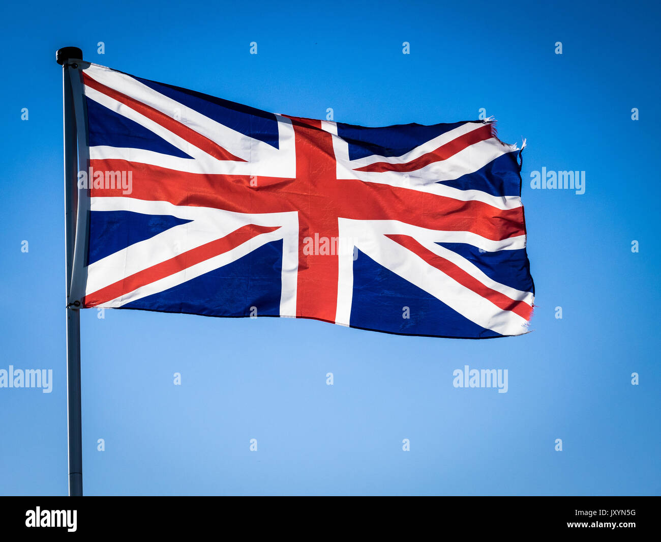 Union Jack flags, backlit by sunshine Stock Photo