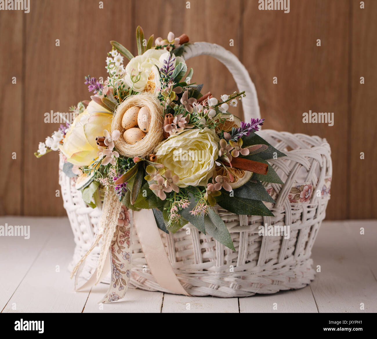 Easter basket. Easter basket decorated with flowers and composition of ...